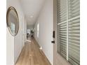 Long hallway with light walls, wood-look flooring, and a view into the living area at 237 Epping St # 89, Stockbridge, GA 30281
