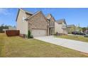 Side view of a two-story house with a long driveway at 824 Lakehaven Ln, Loganville, GA 30052