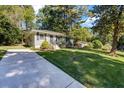 House with a long driveway and a lush green lawn at 1003 Springdale Dr, Marietta, GA 30062