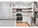 Renovated kitchen featuring stainless steel appliances and wood shelving at 1003 Springdale Dr, Marietta, GA 30062