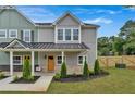 Two-story townhome with inviting front porch and landscaping at 704 Fairgate Rd, Marietta, GA 30064
