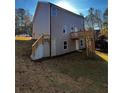 Two-story home with gray siding, deck, and walkout basement at 508 S Fortune Way, Dallas, GA 30157