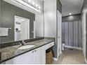 Bathroom with granite countertop, shower, and white cabinets at 10 Perimeter Summit Ne Blvd # 2402, Atlanta, GA 30319