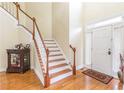 Two story entryway with hardwood floors and staircase at 2080 Misty Oaks Dr, Buford, GA 30519