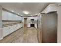 Spacious kitchen featuring white cabinets, granite countertops, stainless steel appliances and wood floors at 3337 Devaughn Ne Dr, Marietta, GA 30066