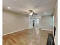 Open concept living space featuring wood floors, a stone fireplace, and a ceiling fan at 3337 Devaughn Ne Dr, Marietta, GA 30066