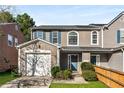 Charming townhome featuring an attached garage, well-kept lawn, and attractive landscaping at 5845 Hampton Ct, Atlanta, GA 30349
