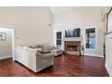 Spacious Gathering room boasts hardwood floors, a stone fireplace, and large sectional sofa at 169 Blue Creek Ln, Loganville, GA 30052