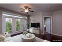 Living room with dark wood floors, large windows, modern decor, and a view to the bedroom at 390 17Th Nw St # 4063, Atlanta, GA 30363