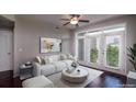Bright living room featuring a plush white sofa, modern decor, and large windows at 390 17Th Nw St # 4063, Atlanta, GA 30363