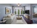 Bright living room featuring a plush white sofa, modern decor, and large windows at 390 17Th Nw St # 4063, Atlanta, GA 30363