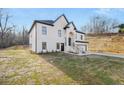 A white, two-story house with a black roof and landscaping at 4410 Ross Estates Ct, Snellville, GA 30039
