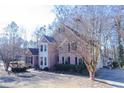 Side view of a brick home with landscaping and a deck at 1325 Starboard Way, Cumming, GA 30041