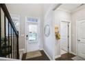 Bright entryway with staircase, hardwood floors, and access to powder room at 2475 Barley Crest Pass, Cumming, GA 30040