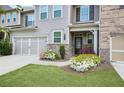 Townhouse exterior with landscaping, double garage, and front entry at 2475 Barley Crest Pass, Cumming, GA 30040