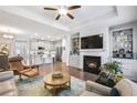 Open living room with fireplace, built-in shelving, and kitchen view at 2475 Barley Crest Pass, Cumming, GA 30040