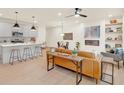Open concept living area with a modern kitchen, island, and tan leather couch at 702 Fairgate Rd, Marietta, GA 30064