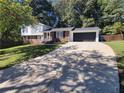 Long driveway leading to a two-car garage at 208 Willows Ct, Riverdale, GA 30274