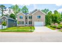 Two-story brick home with a white garage door and landscaped lawn at 5649 Eagles Watch, Douglasville, GA 30135