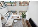High-ceilinged living room with hardwood floors, city views, and stylish decor at 260 18Th Nw St # 10311, Atlanta, GA 30363