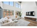Modern living room featuring hardwood floors, large windows, and comfortable seating at 260 18Th Nw St # 10311, Atlanta, GA 30363