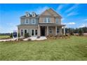 Two-story home with gray siding and a covered porch at 313 Foxglove Way, Mcdonough, GA 30253