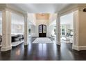 Two-story entryway with hardwood floors and formal dining room at 9680 Almaviva Dr, Alpharetta, GA 30022