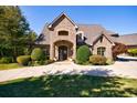 Brick home with landscaped yard and driveway at 9680 Almaviva Dr, Alpharetta, GA 30022