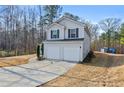 Two-story home with a two-car garage and walkway leading to the front door at 125 Gum Creek Lndg, Oxford, GA 30054