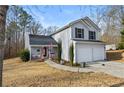 Charming home with a cozy front porch, complete with a walkway to the two-car garage at 125 Gum Creek Lndg, Oxford, GA 30054