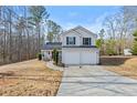 Well-maintained two-story home with a spacious driveway and landscaped front yard at 125 Gum Creek Lndg, Oxford, GA 30054