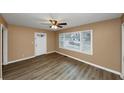Living room with new flooring and ceiling fan at 1881 Broad Ave, East Point, GA 30344