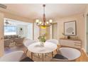 Inviting dining room featuring modern decor, a stylish chandelier, and hardwood floors, perfect for gatherings at 1931 Oana Sw St, Atlanta, GA 30310