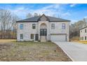 Two-story brick home with a large driveway and attached garage at 4400 Ross Estates Ct, Snellville, GA 30039