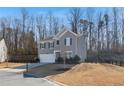 Two story home with a well-maintained lawn and a two-car garage with a fenced yard at 4770 Alford Commons, Cumming, GA 30028