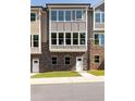 Modern three-story townhome with stone accents and large windows at 3790 Jack Vernon Cir, Powder Springs, GA 30127