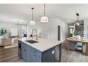 Modern kitchen island with quartz countertop and gray cabinets at 3827 Cottage Cir, Tucker, GA 30021