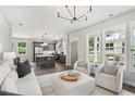 Open living room with kitchen and island, featuring neutral colors at 3827 Cottage Cir, Tucker, GA 30021