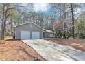 View of the home's driveway leading up to the two-car garage and charming front entrance at 7018 Chimney Ridge Dr, Riverdale, GA 30296