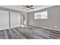 Bedroom with grey walls, wood-look floors, and double closet at 4701 Flat Shoals Rd # 49C, Union City, GA 30291