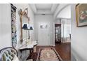 Bright entryway with hardwood floors, ornate mirror, and decorative rug at 121 Meridian Dr, Woodstock, GA 30188