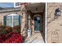 Inviting front entrance with dark green door and brick accents at 121 Meridian Dr, Woodstock, GA 30188