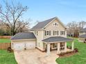 A lovely home with a two-car garage and inviting front porch situated on a well-manicured lot at 3 Derrick Ave, Hampton, GA 30228