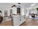 Open living space with a kitchen island, fireplace, and dining area at 2645 Shadow Woods Ne Cir, Marietta, GA 30062