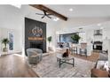 Bright open-concept living room featuring fireplace, modern furnishings, and seamless flow into a updated kitchen at 2645 Shadow Woods Ne Cir, Marietta, GA 30062