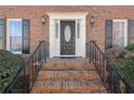 Brick steps leading to a dark-stained front door at 5659 Brookstone Nw Dr, Acworth, GA 30101