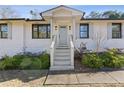 Renovated front entry with light gray door and white columns at 2439 Woodridge Dr, Decatur, GA 30033