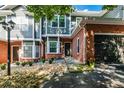 Two-story townhouse with brick and gray siding, double garage, and manicured landscaping at 2680 Pine Tree Ne Rd # 2, Atlanta, GA 30324