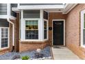 Inviting front entrance to a townhome with a black door and bay window at 2680 Pine Tree Ne Rd # 2, Atlanta, GA 30324