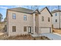 Tan brick two-story house with a two-car garage at 4420 Ross Estates Ct, Snellville, GA 30039